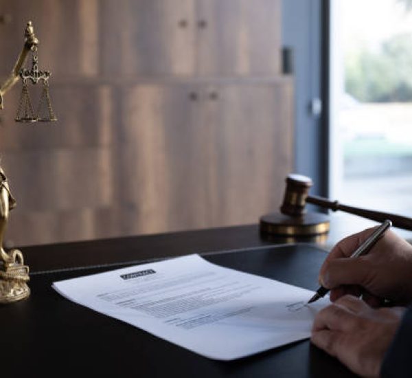 Judge or Legal advisor lawyer examining and signing legal documents.